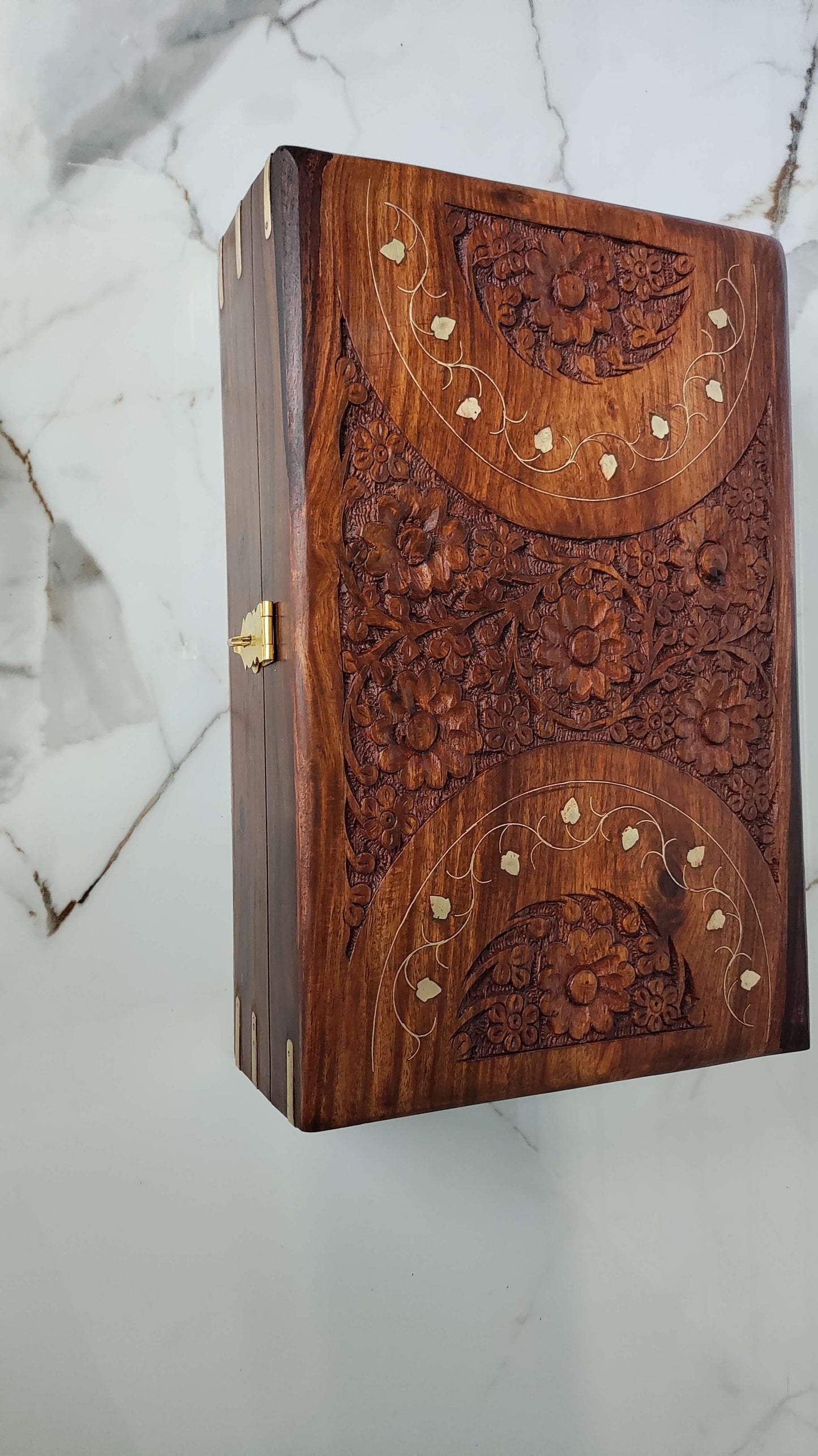 Front view of the box highlighting the brass latch and reinforced brass corner brackets.