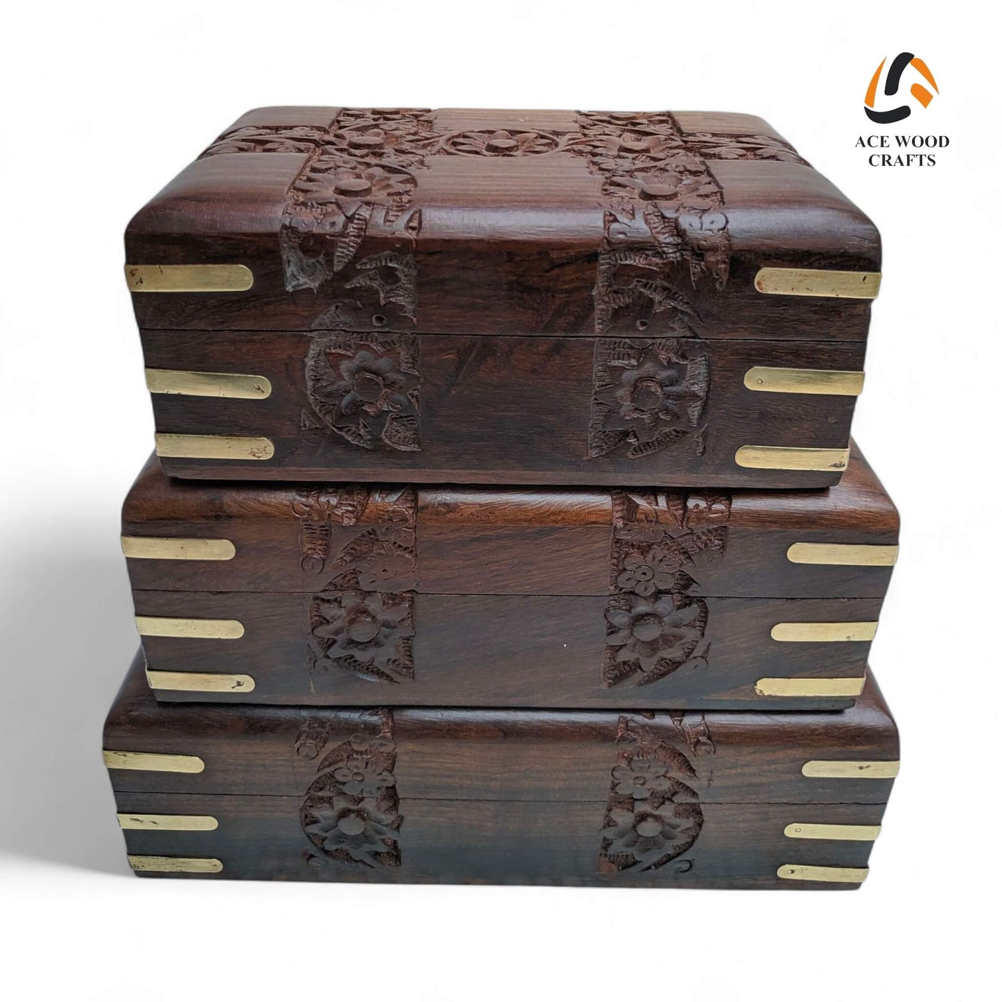 Front view of antique-style nesting jewellery boxes showing detailed floral carvings on the lid and front panel