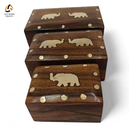 Top view of nesting Sheesham wood boxes featuring handcrafted brass elephant inlays and decorative brass dots.