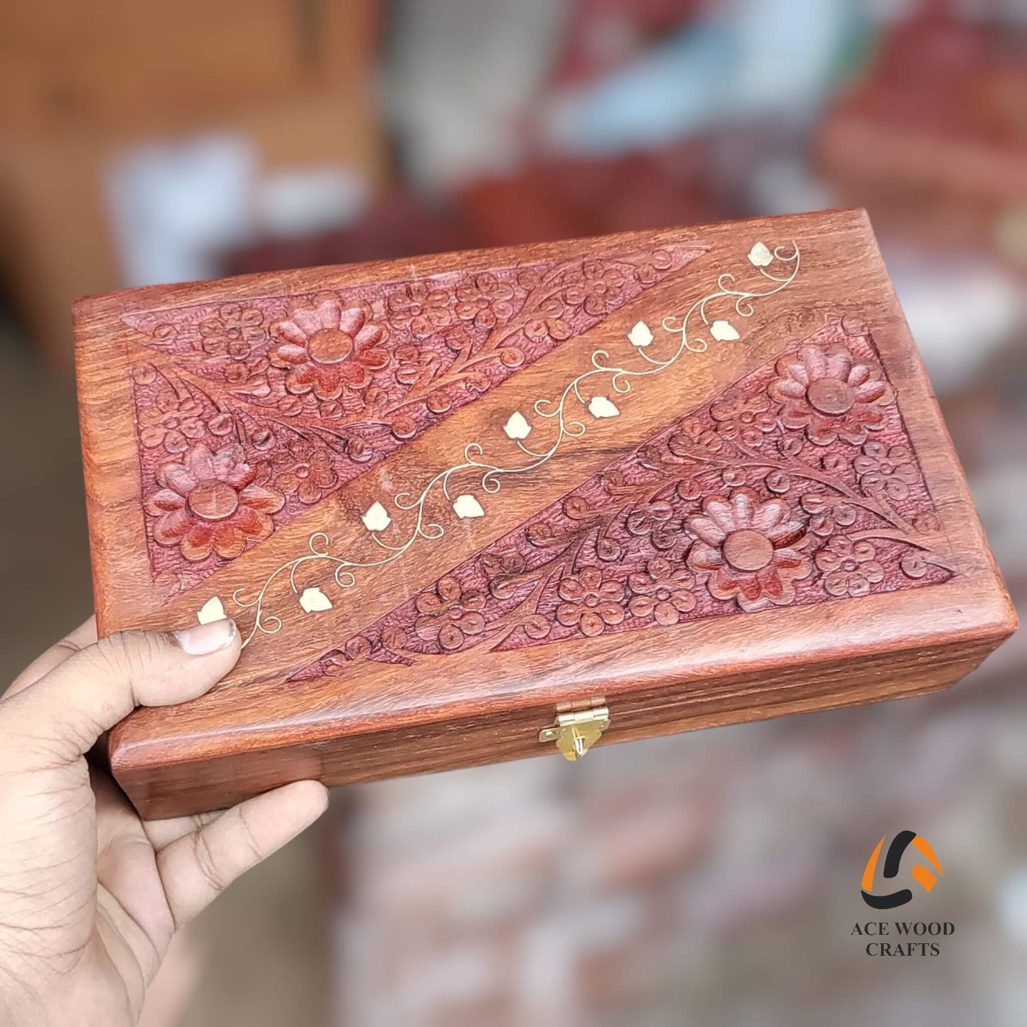 Hand holding a wooden box with intricate carvings and floral patterns, brand 'Ace Wood Crafts' visible.