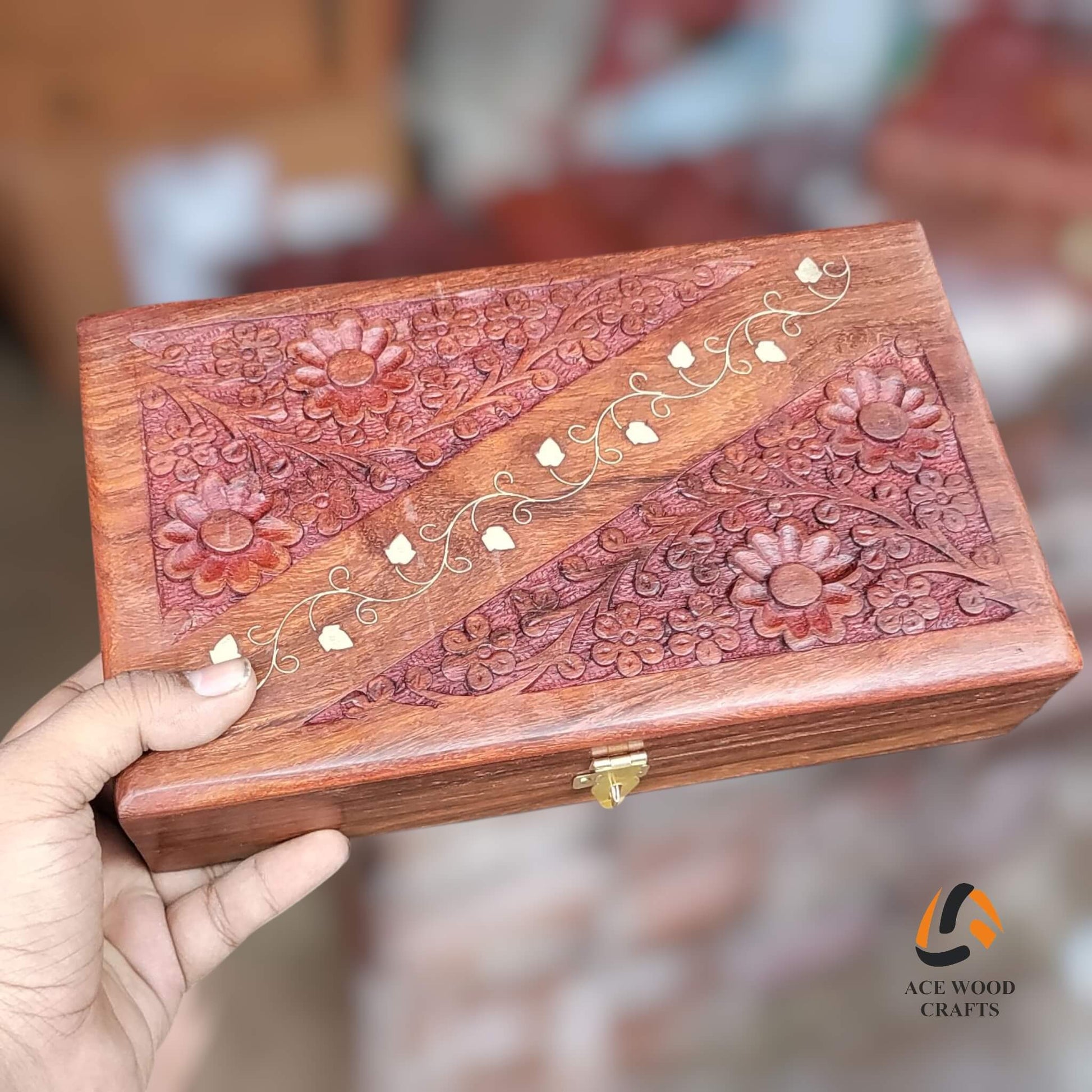 Hand holding a wooden box with intricate carvings and floral patterns, brand 'Ace Wood Crafts' visible.