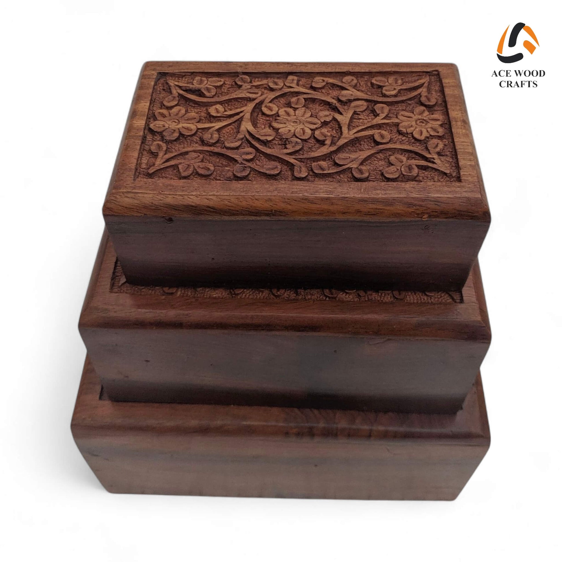 Top view of stacked Sheesham wood jewellery boxes with intricate floral carving on sliding lids.