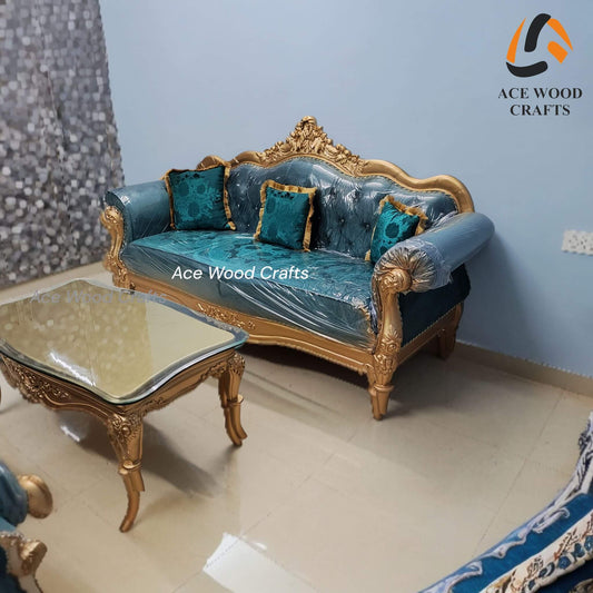 Front view of the 3-seater royal teak wood sofa in antique gold and teal blue velvet.