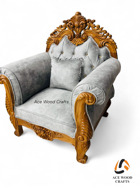Front view of the single royal sofa chair in natural teak wood finish with grey tufted velvet.