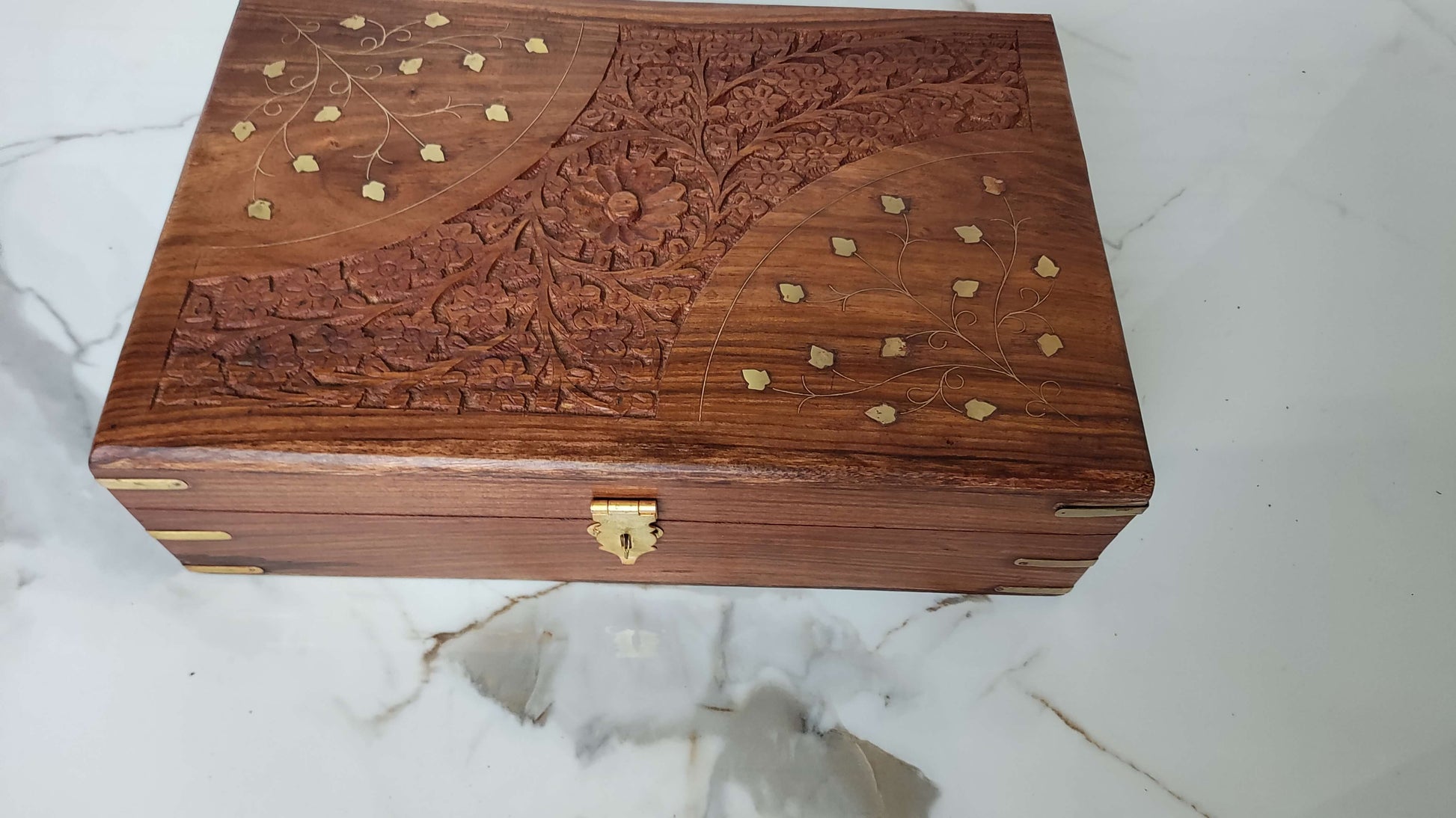 Top view of rectangular wooden tray with deep grooved texture and brass leaf inlay.