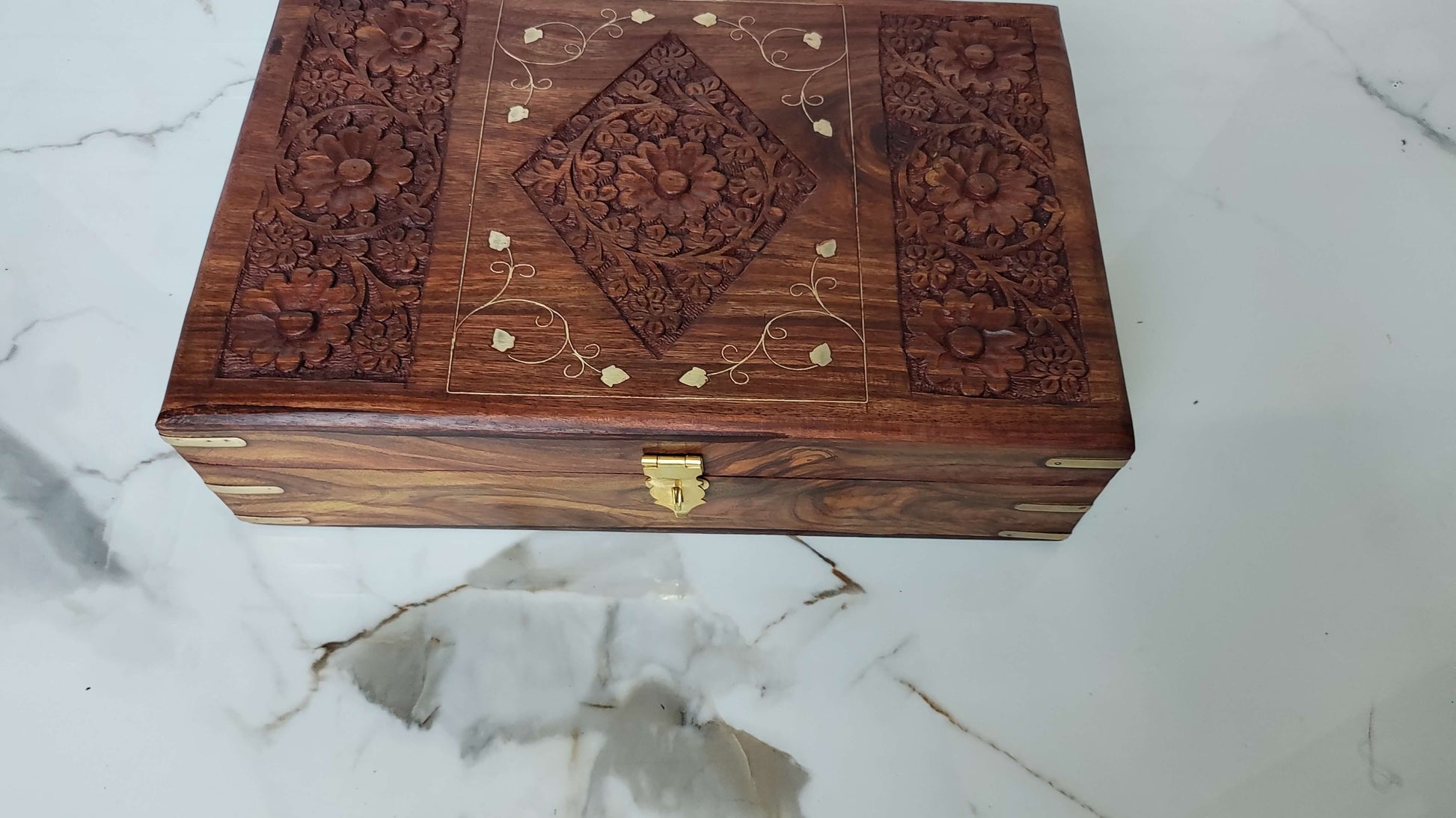 Top view of rectangular wooden tray with deep grooved texture and brass leaf inlay.