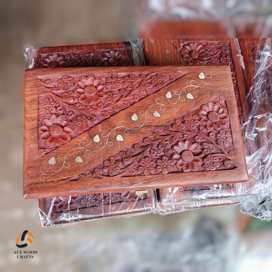 Top view of luxury wooden box featuring intricate floral carving and brass vines.