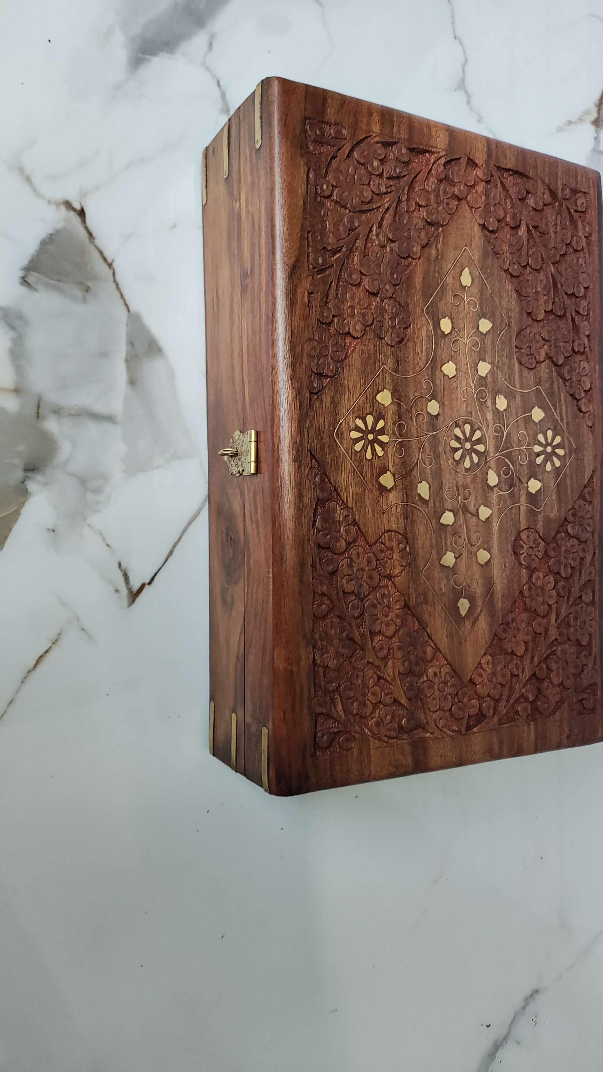 Top view showing intricate floral carving and brass leaf inlay on Sheesham wood.