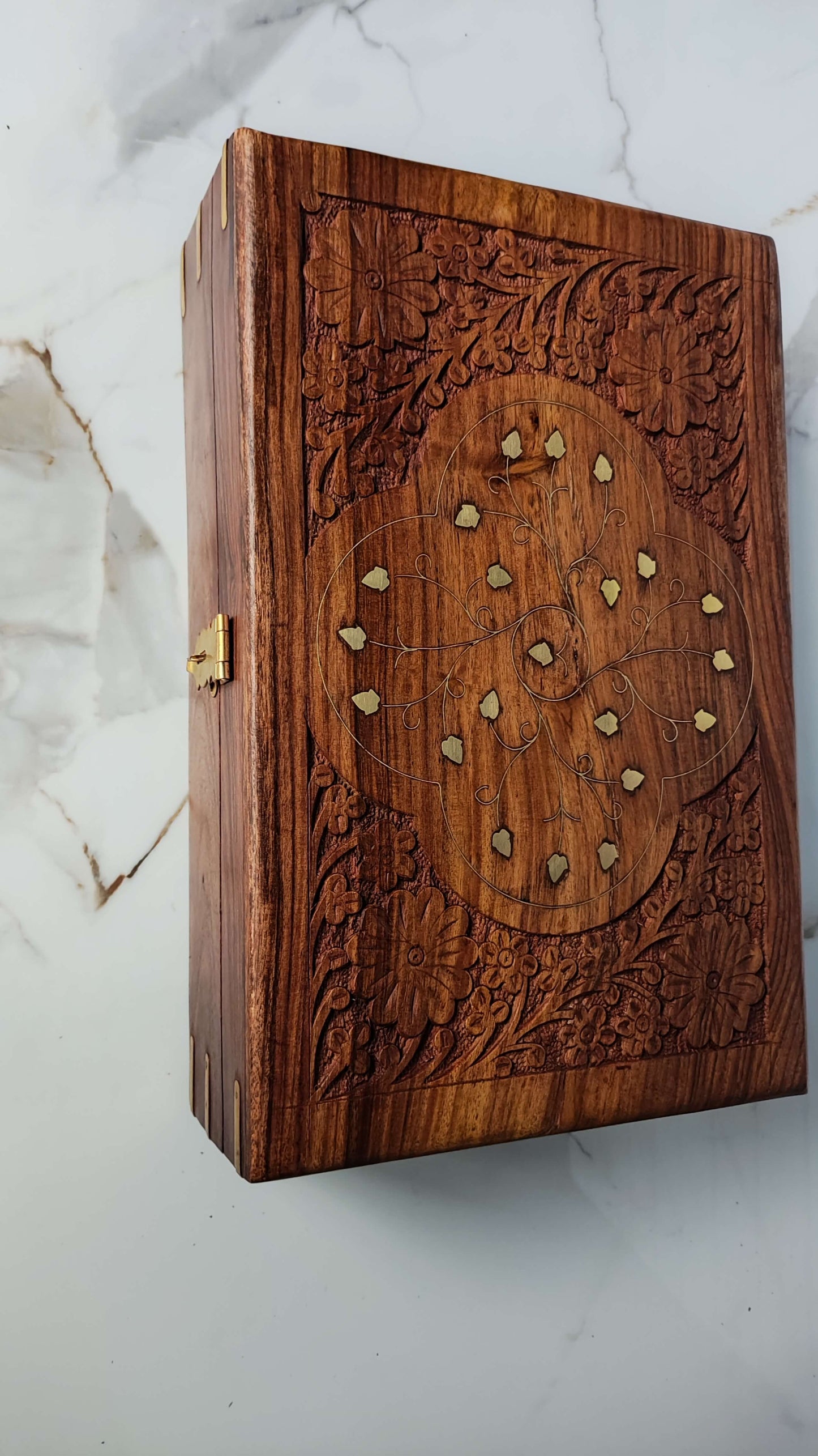 Top view showing intricate floral carving and brass leaf inlay on Sheesham wood.