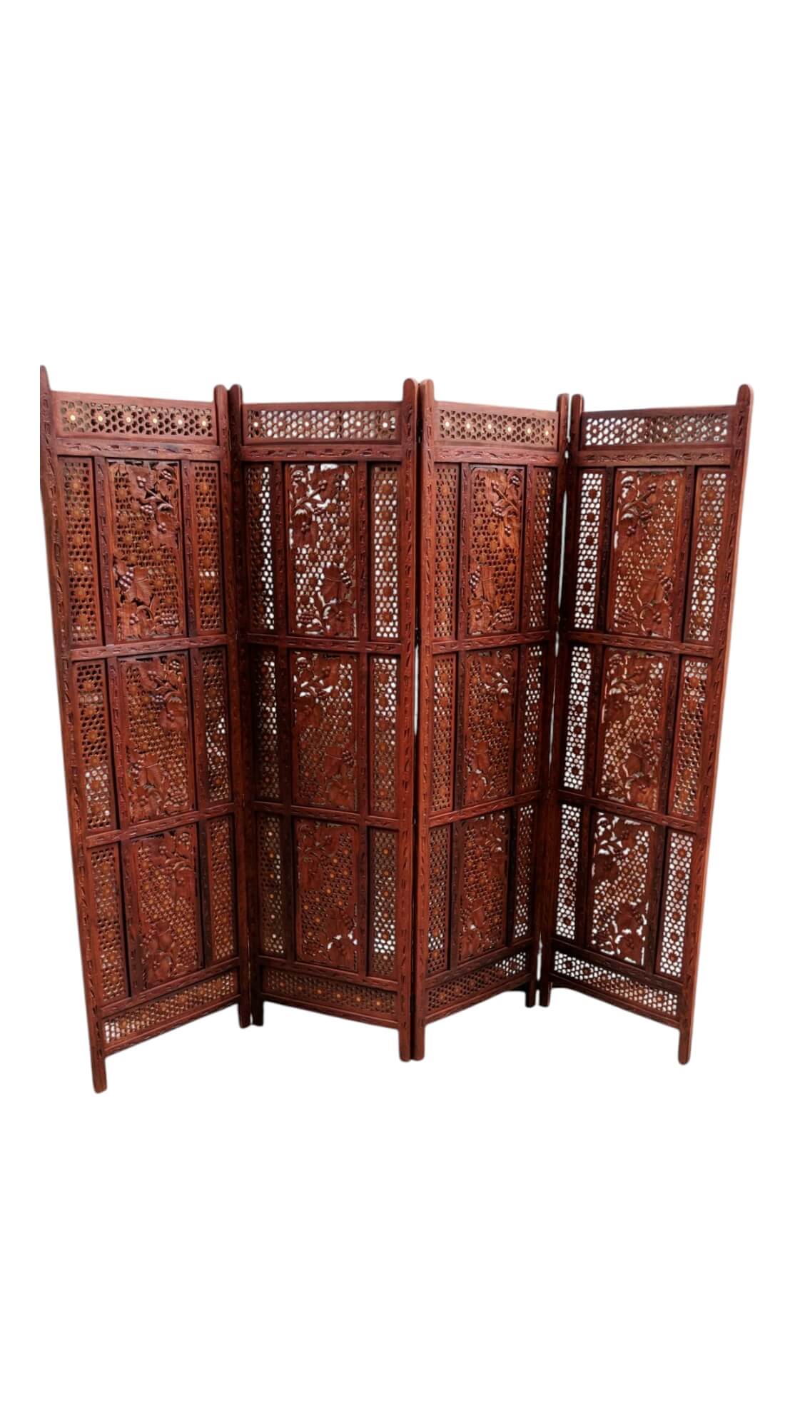 Angled view of a handcrafted folding screen acting as a privacy divider in a living space.