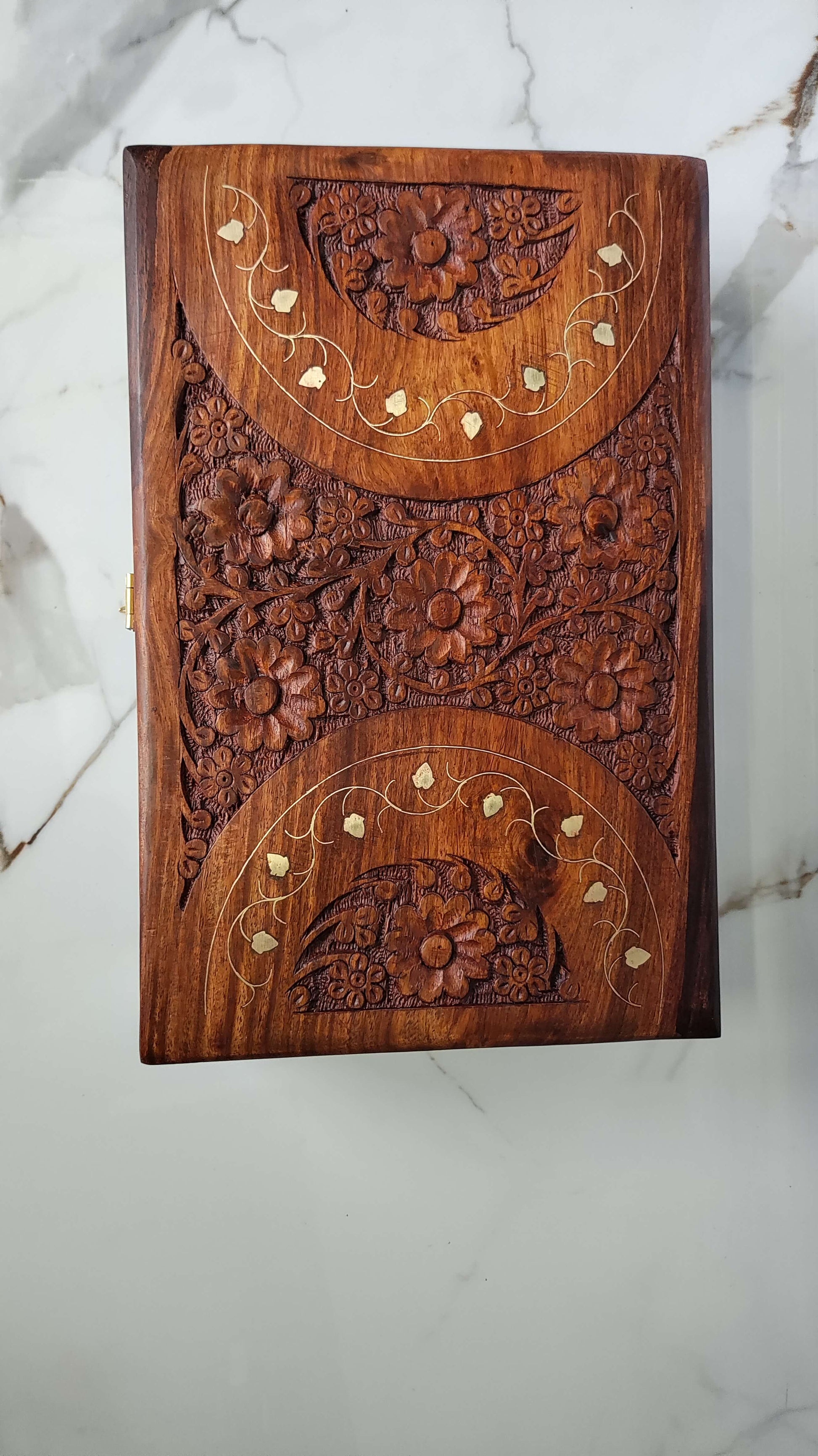 Top view showing the cross pattern dividing the lid into four floral carved sections.