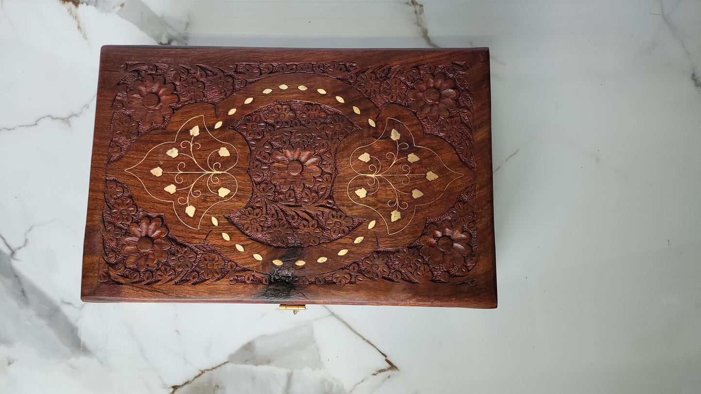 Top view showing the cross pattern dividing the lid into four floral carved sections.