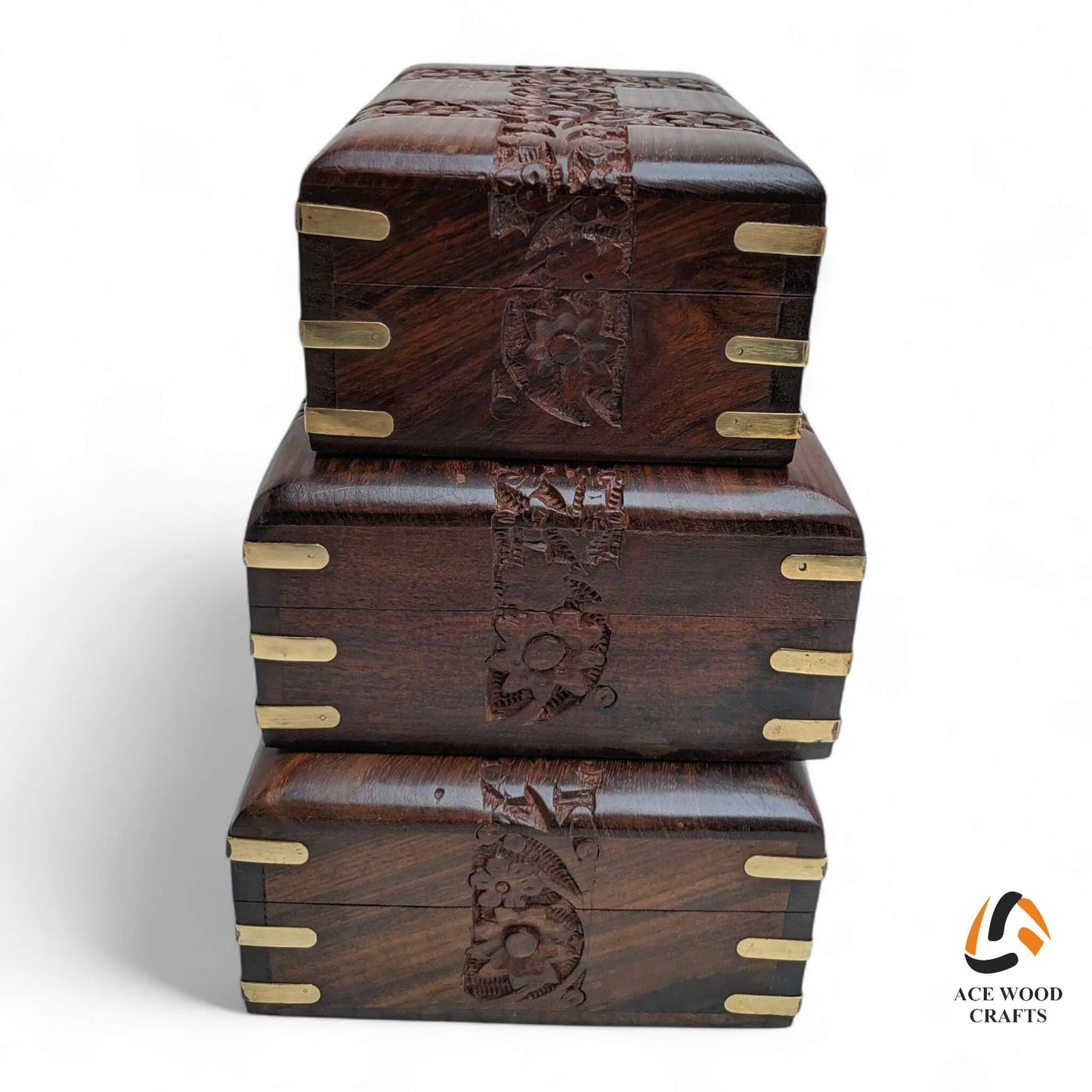 Stack of handcrafted wooden storage boxes with polished brass corners and dark walnut finish.