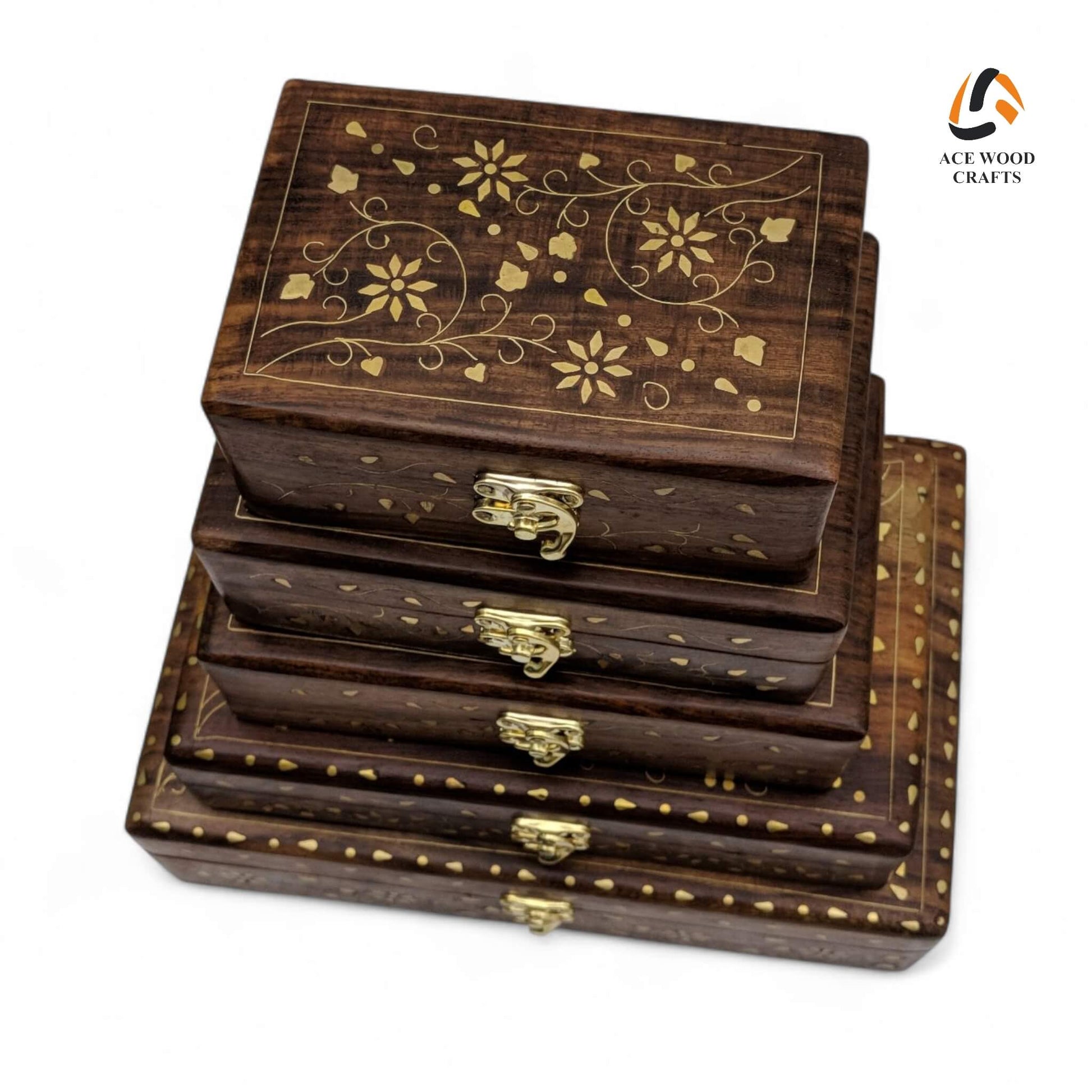 Top view of 5-piece nesting wooden box set featuring intricate golden brass floral vine inlay.