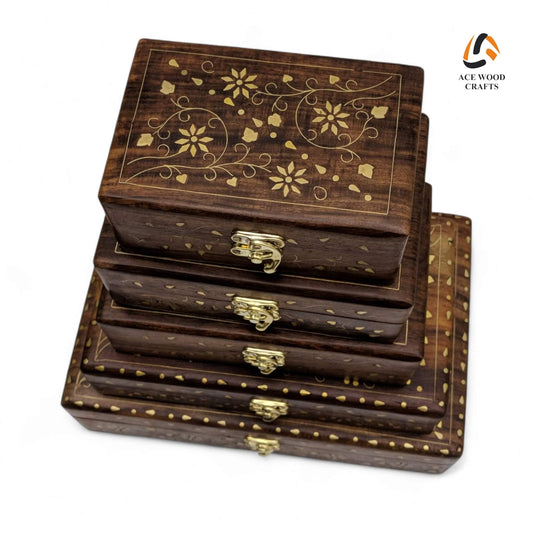 Top view of 5-piece nesting wooden box set featuring intricate golden brass floral vine inlay.