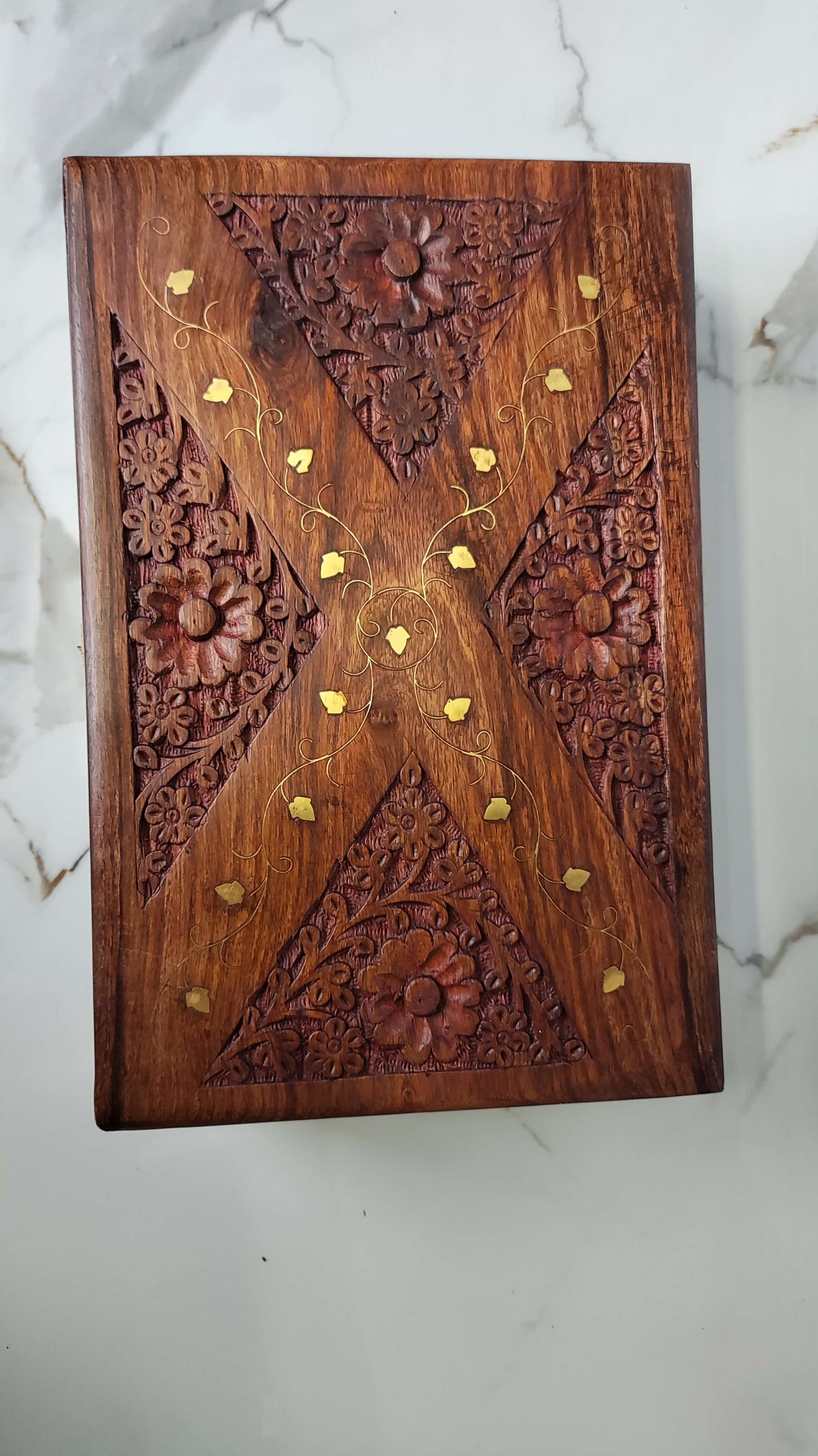 Top view detailing the geometric diamond brass inlay and floral carving on the lid.
