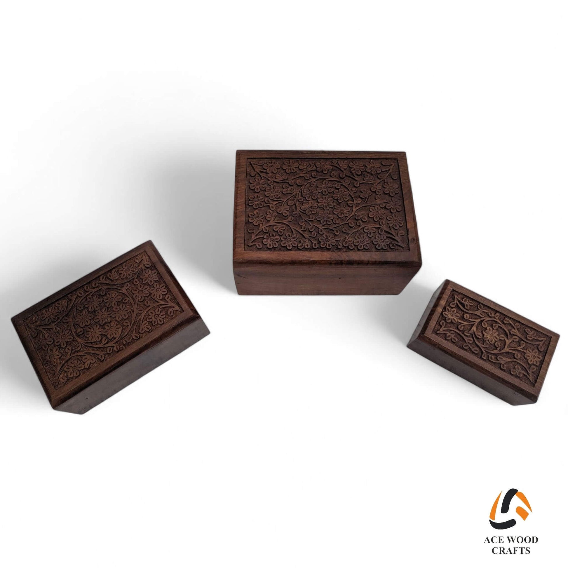 Top-down view of handcrafted floral wooden boxes arranged in a neat stack